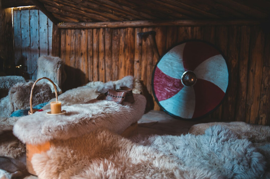 Cosy wooden alpine chalet interior with wool blankets
