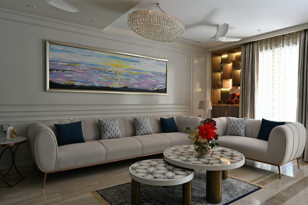 Elegant bright living room with art on the wall and designer sofa